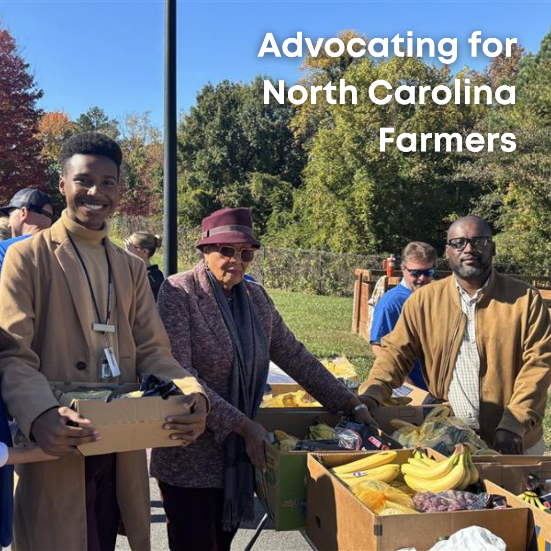 Rep. Adams poses with a box of food at a food pantry event