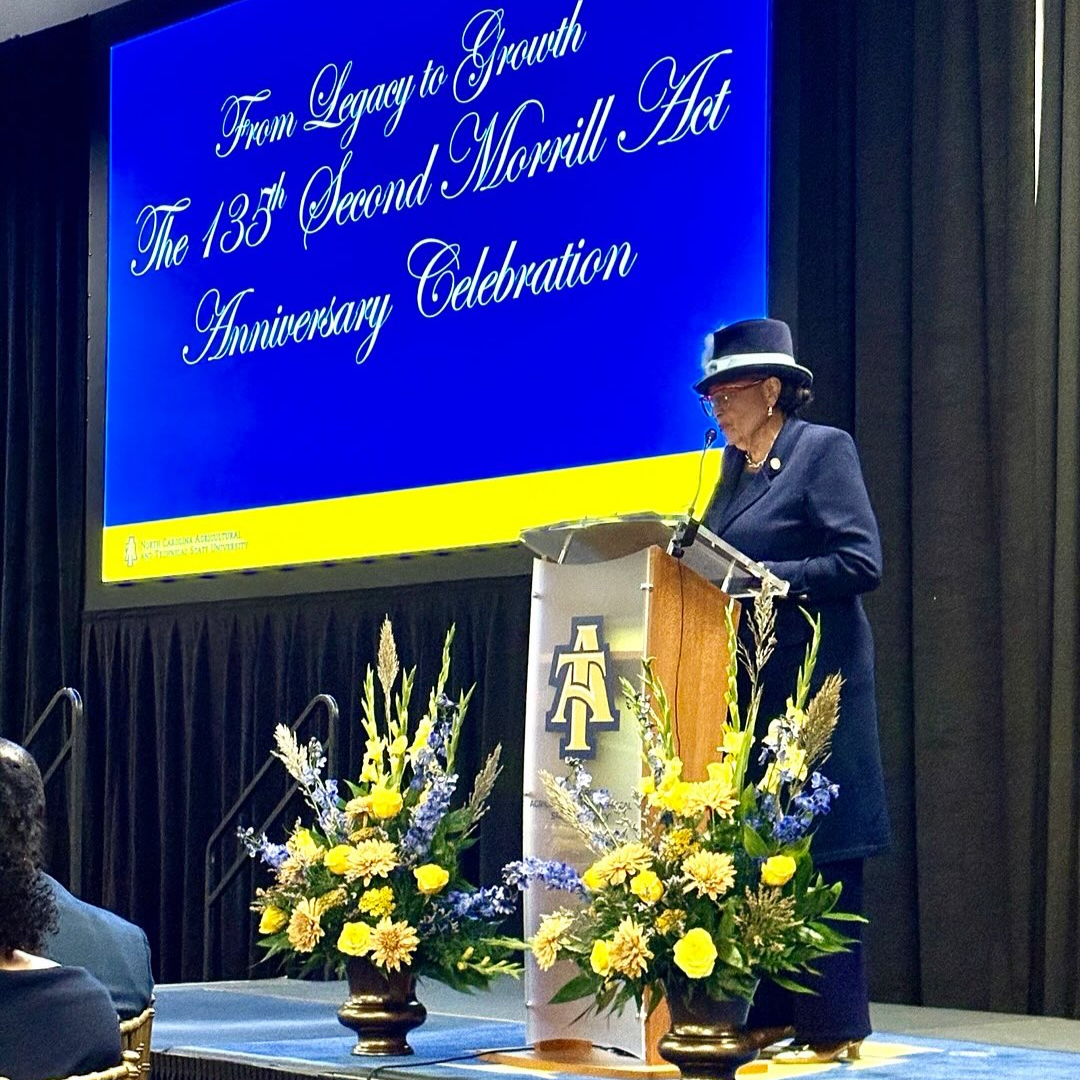 Rep. Adams speaking at a podium at NC A&T.