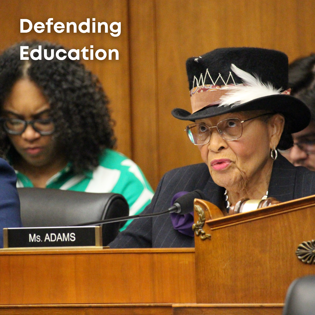 Rep. Adams speaks at the ranking member podium at an E&W meeting