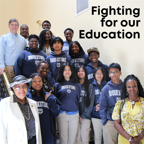 Rep. Adams poses on a stairwell with students and teachers from Brookstone